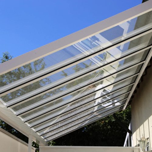 slanted skylights at an angle with blue sky and trees in background by Apollo Industries