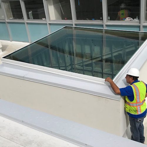 skylight on commercial building with construction worker by Apollo Industries